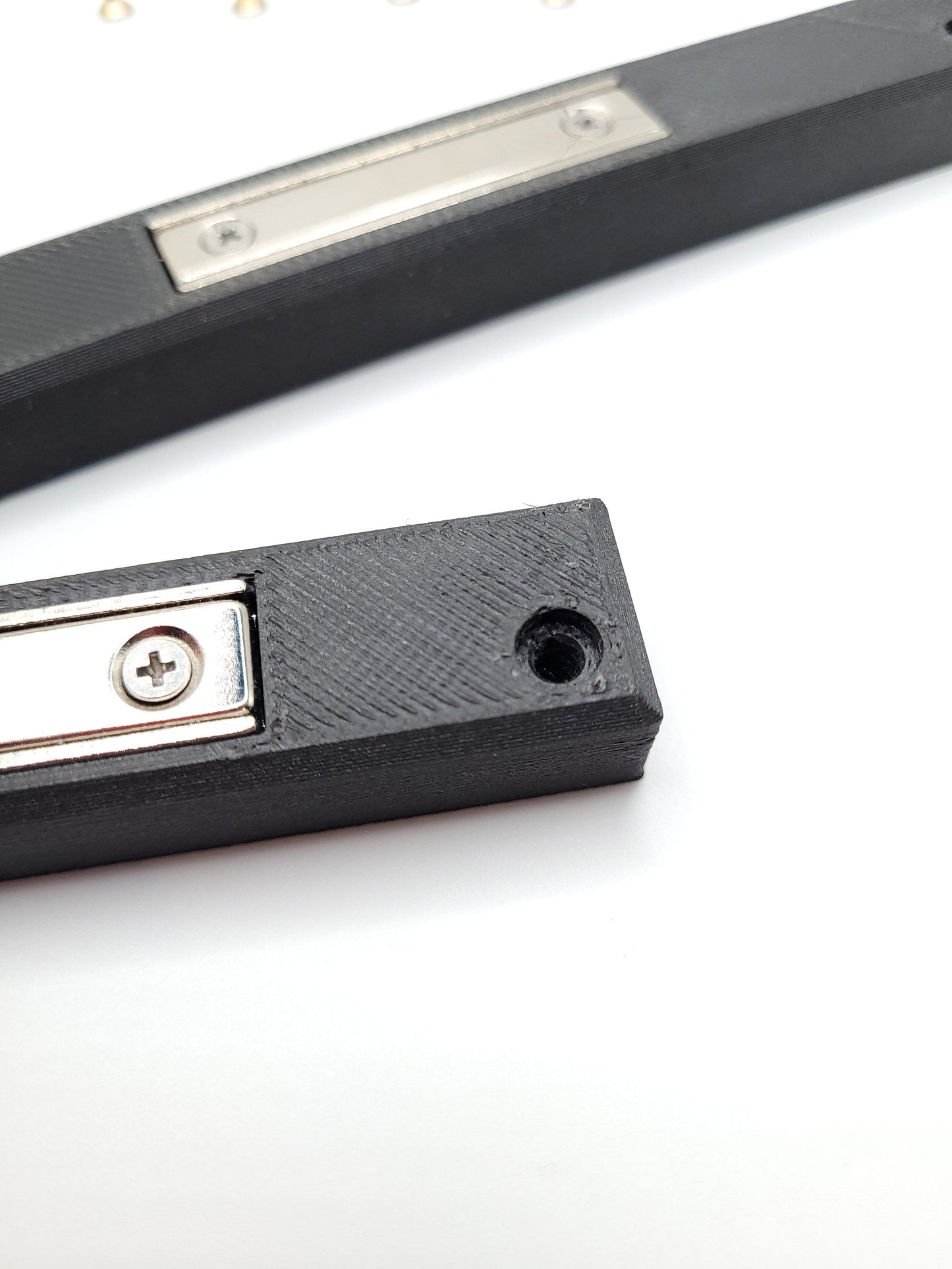 Milwaukee M12 M18 Charger Mount, Cat. No. 48-59-1812, Uses Two Neodymium Bar Magnets for Strong Hold on Metal Surface